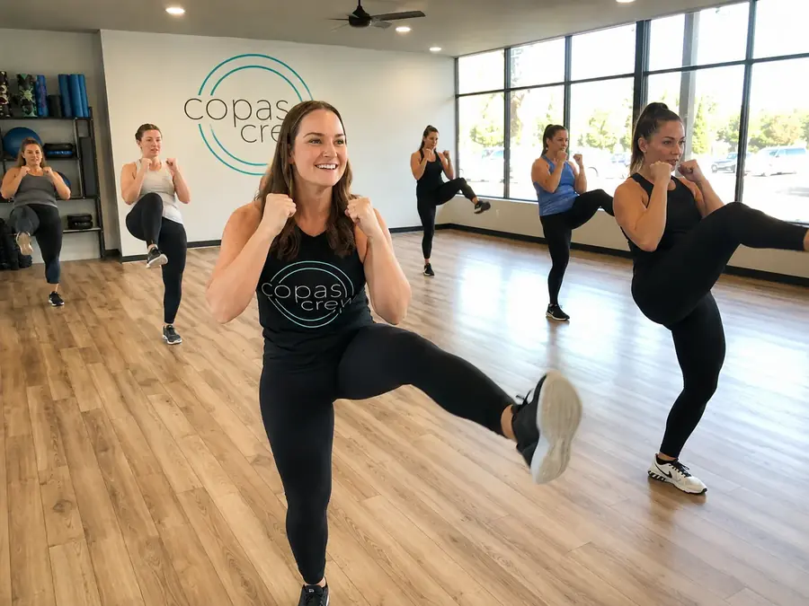 Cardio Kickboxing Lower Body Bootcamp at Copas Crew Fitness — members driving knee raises with guards up